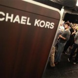 Models and staff prepare backstage before the Michael Kors Spring 2011 collection during New York Fashion Week